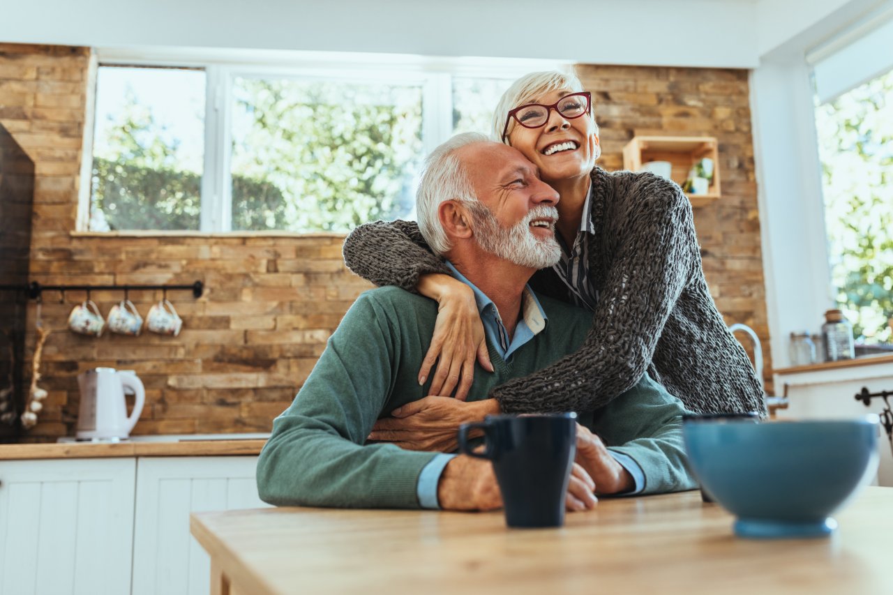 Older couple hugging while wearing compression.